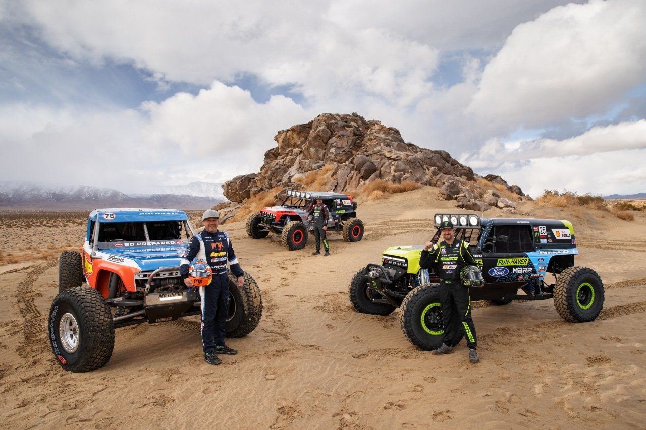 Jason Scherer, Loren Healy, and Vaughn Gittin Jr. with their Bronco ULTRA4 4400 racing trucks