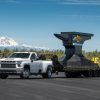 Front side view of Chevrolet Silverado 3500HD towing giant anvil