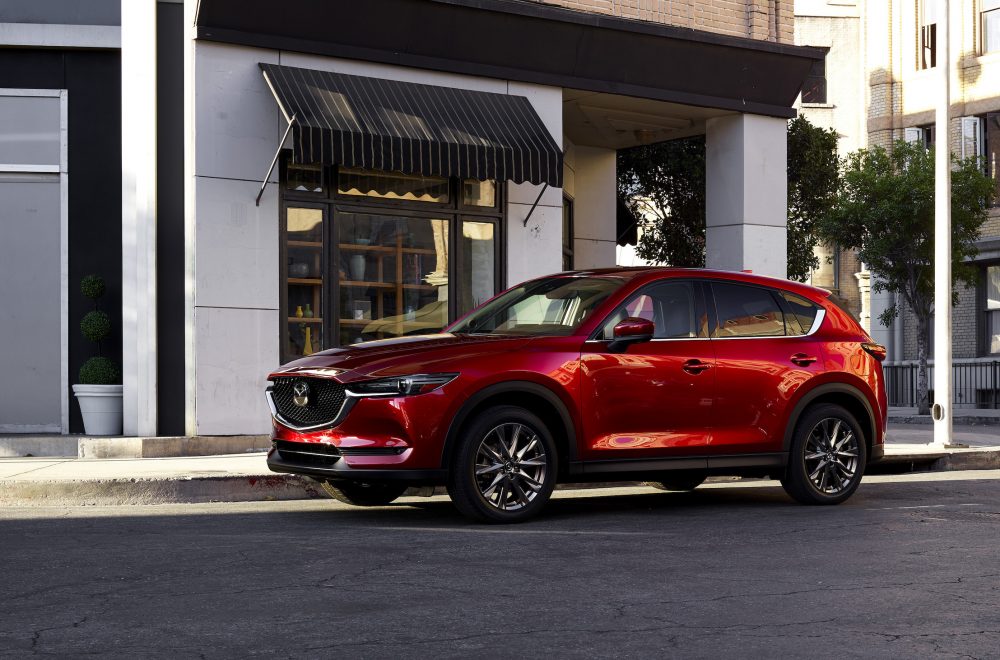 2021 Mazda CX-5 in front of a city storefront