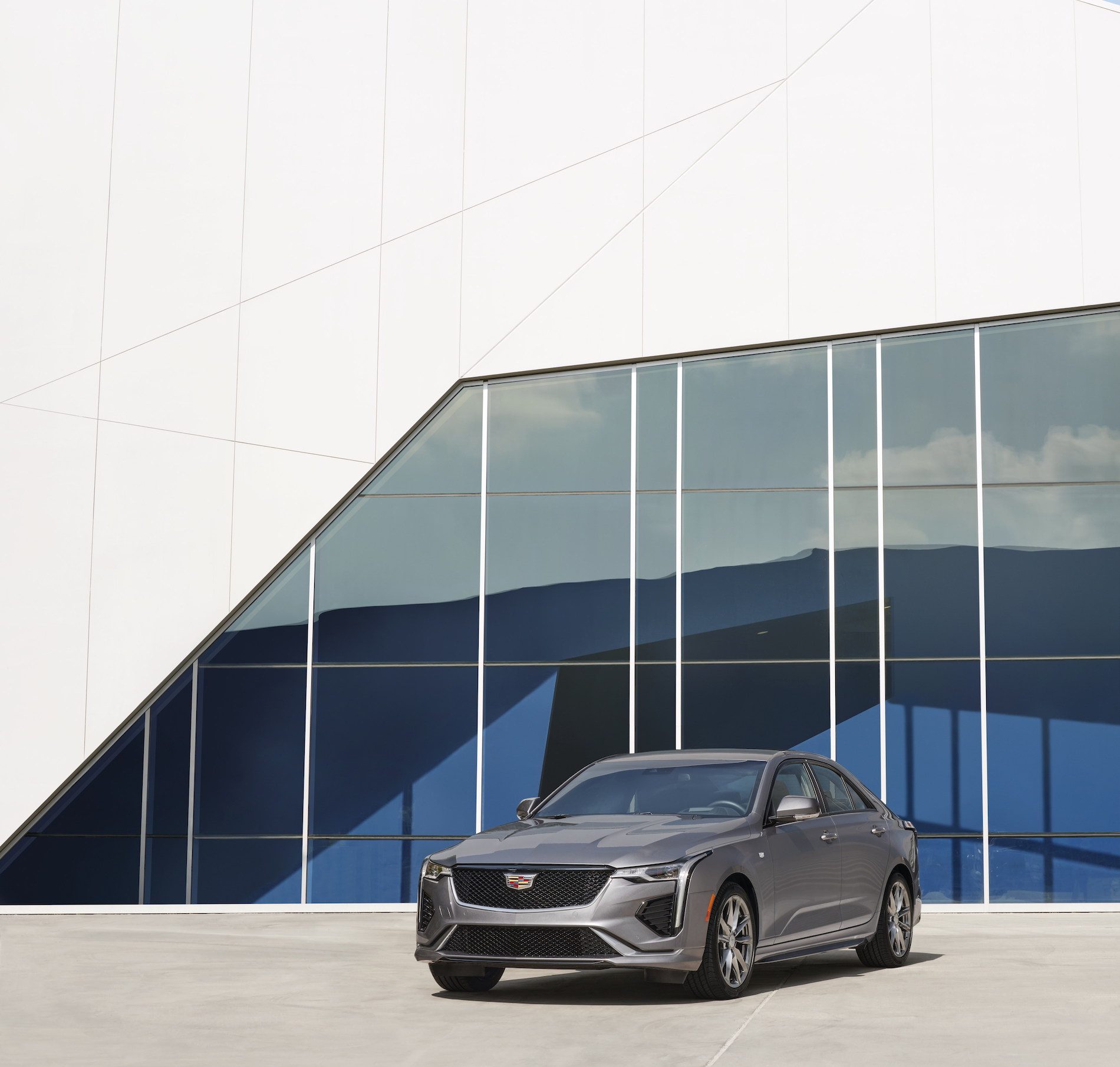 Front view of the 2021 Cadillac CT4 in front of a blue and white building