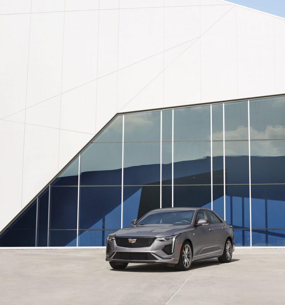 Front view of the 2021 Cadillac CT4 in front of a blue and white building