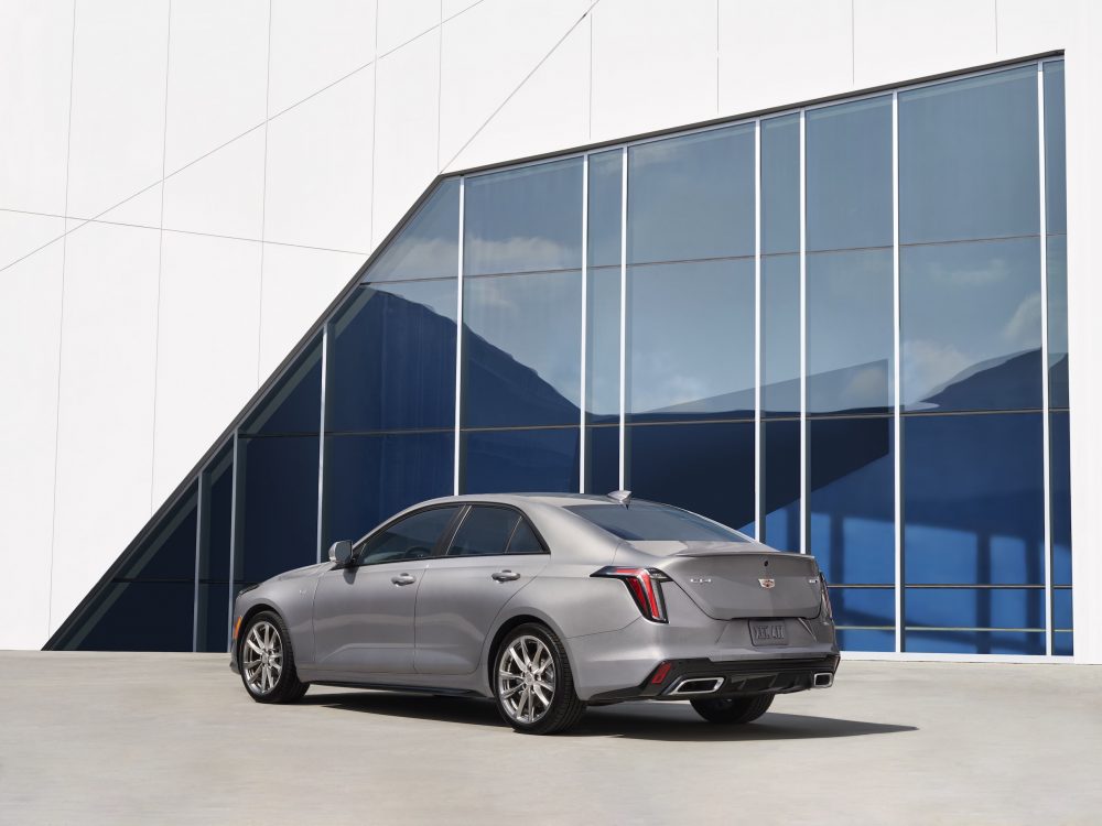 Rear view of the 2021 Cadillac CT4 in front of a blue and white building