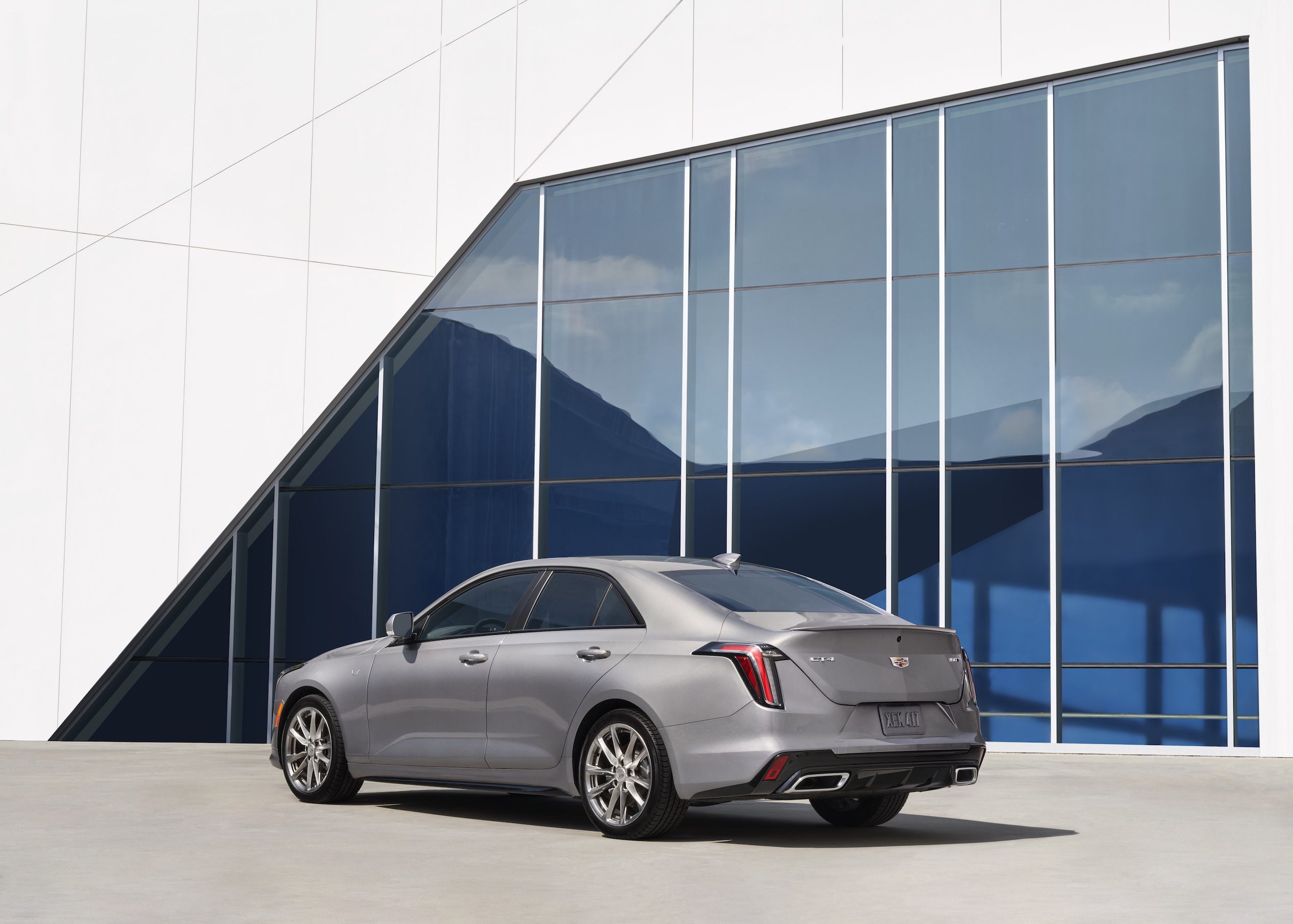 Rear view of the 2021 Cadillac CT4 in front of a blue and white building