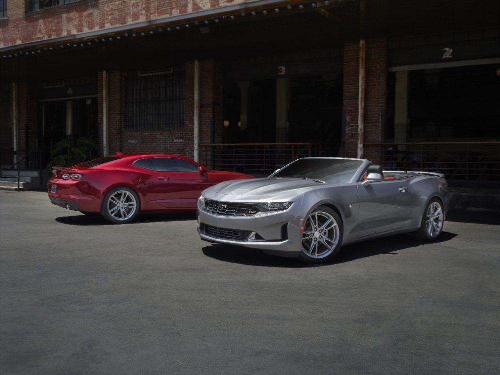 2021 Chevrolet Camaro LS and LT parked by a brick building