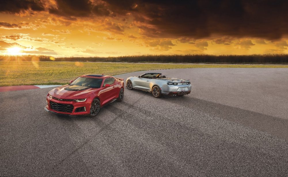 Two 2021 Chevrolet Camaro ZL1 models parked on a track at sunset