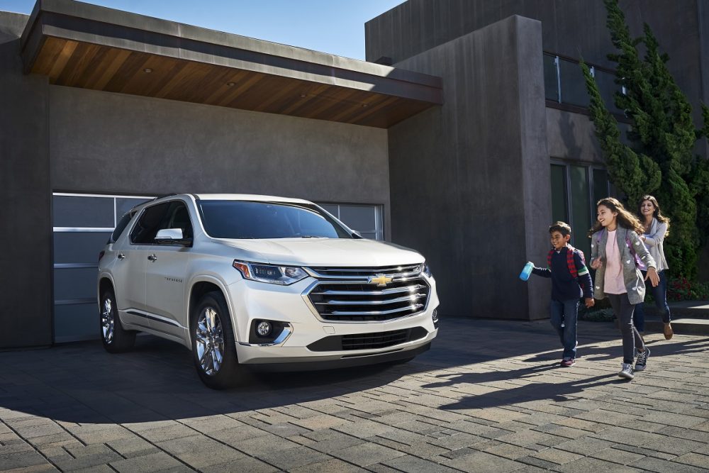 A family walking to the 2021 Chevrolet Traverse High Country in the driveway