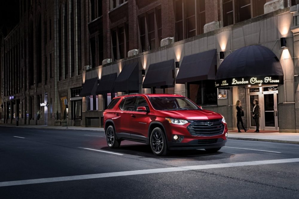 Red 2021 Chevrolet Traverse RS driving at night in a city