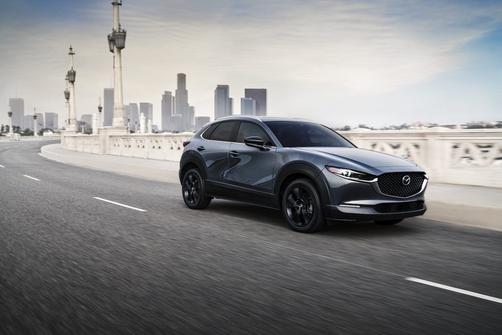2021 Mazda CX-30 driving away from a big city