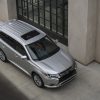 The 2021 Mitsubishi Outlander PHEV parked by a building