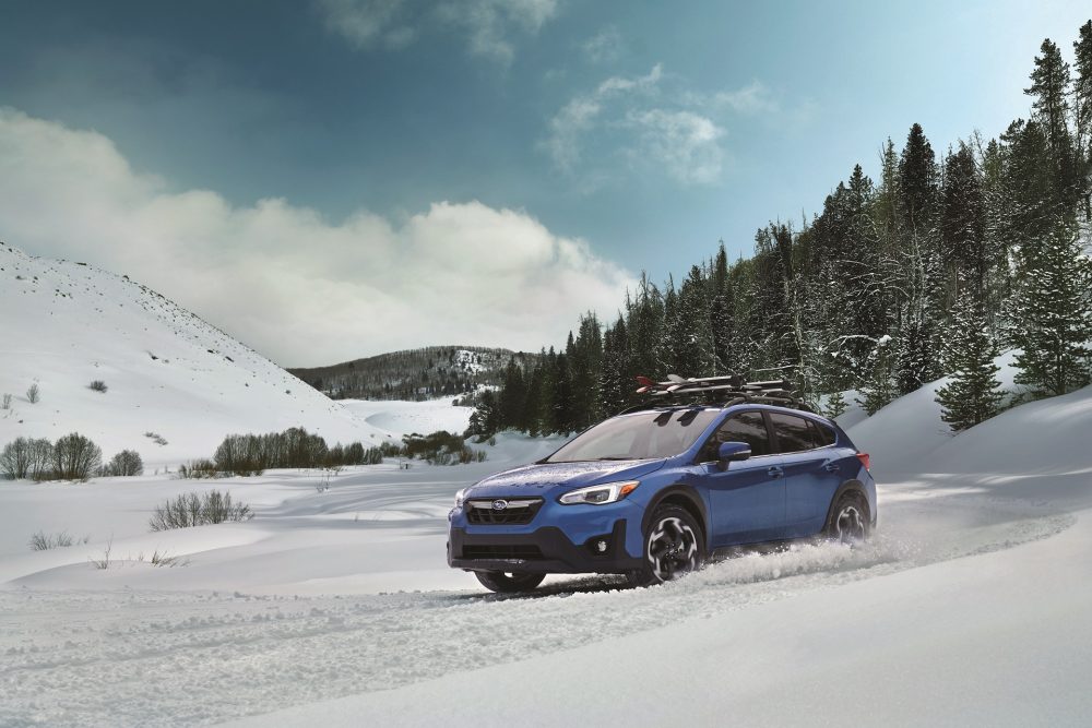 A 2021 Subaru Crosstrek driving through the snow. No wonder it led posted record February sales numbers.