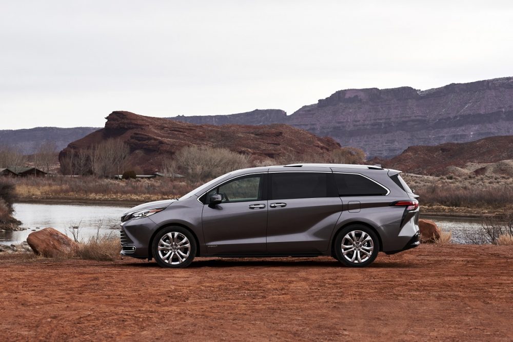 2021 Toyota Sienna Platinum parked on red soil with a pond and some red-rock mountains in the background