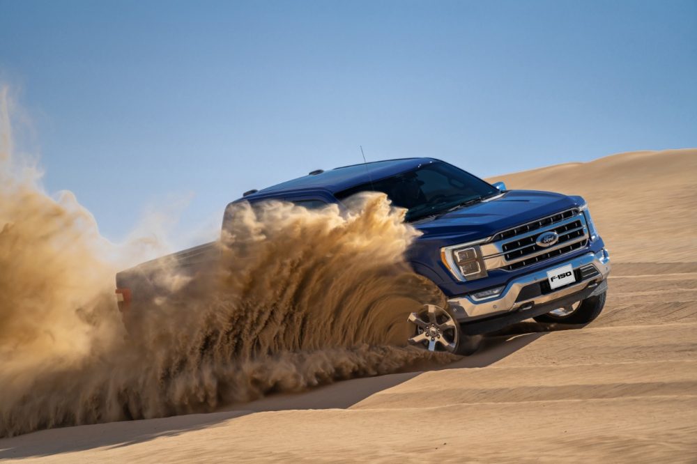 2021 Ford F-150 kicks up sand while driving on a dune