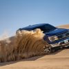 2021 Ford F-150 kicks up sand while driving on a dune