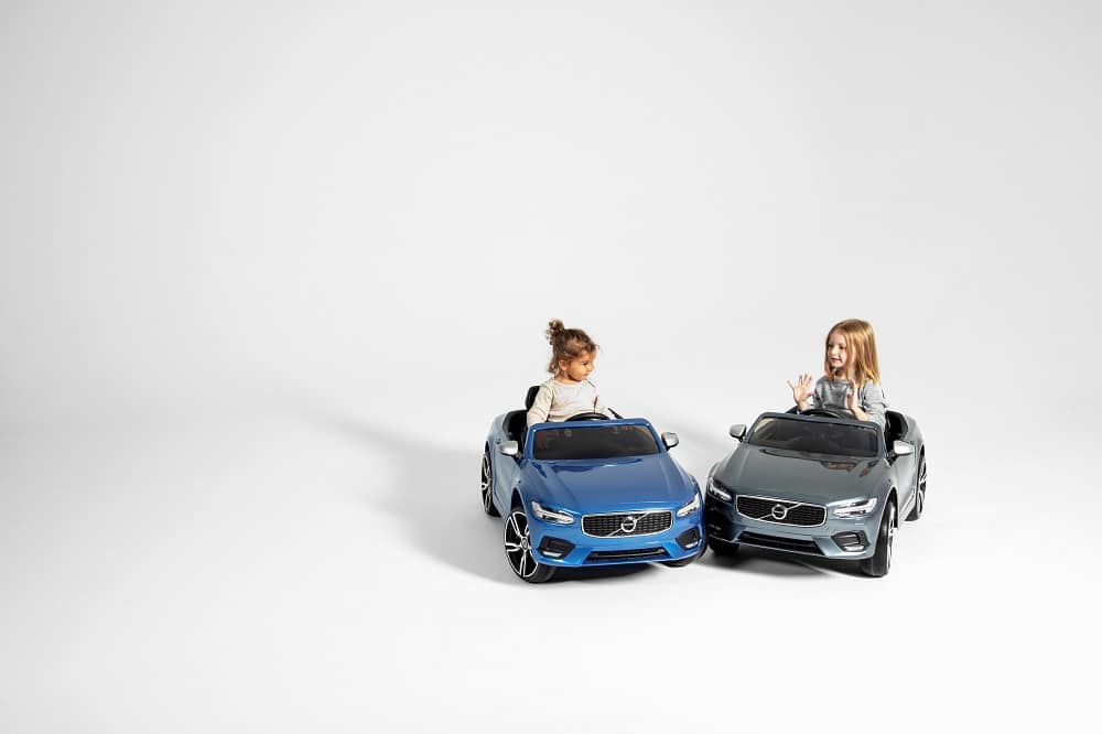 Children in toy Volvo cars