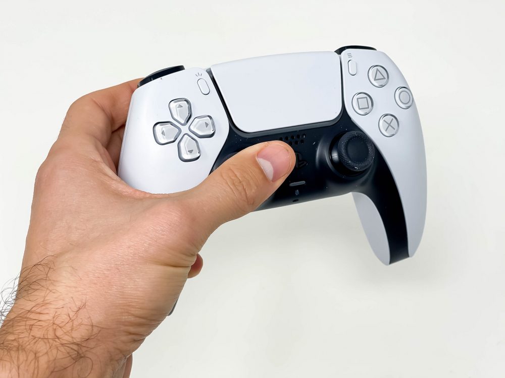 A hand holding the new PlayStation DualSense controller. Its unique haptic feedback brings a new dimension to many games' core mechanics.