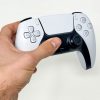 A hand holding the new PlayStation DualSense controller. It's unique haptic feedback brings a new dimension to many games' core mechanics.