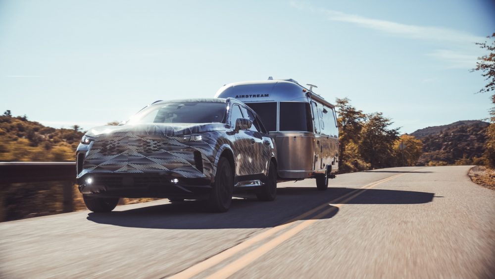 INFINITI QX60 towing an Airstream RV on the road