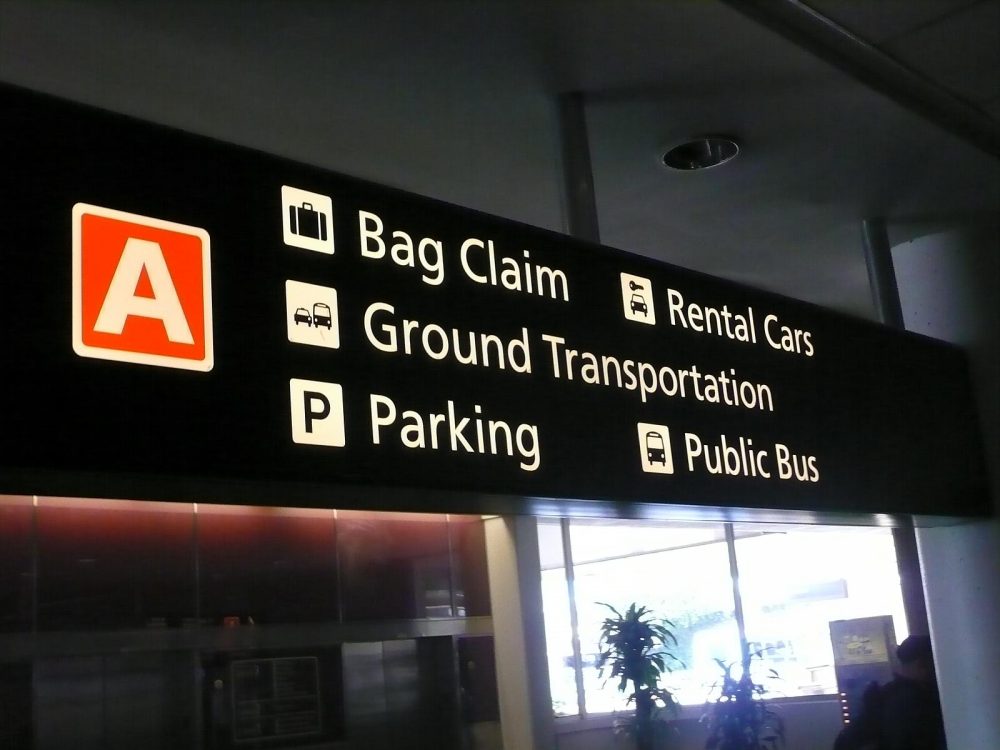 Airport sign directing passengers to the rental car desks