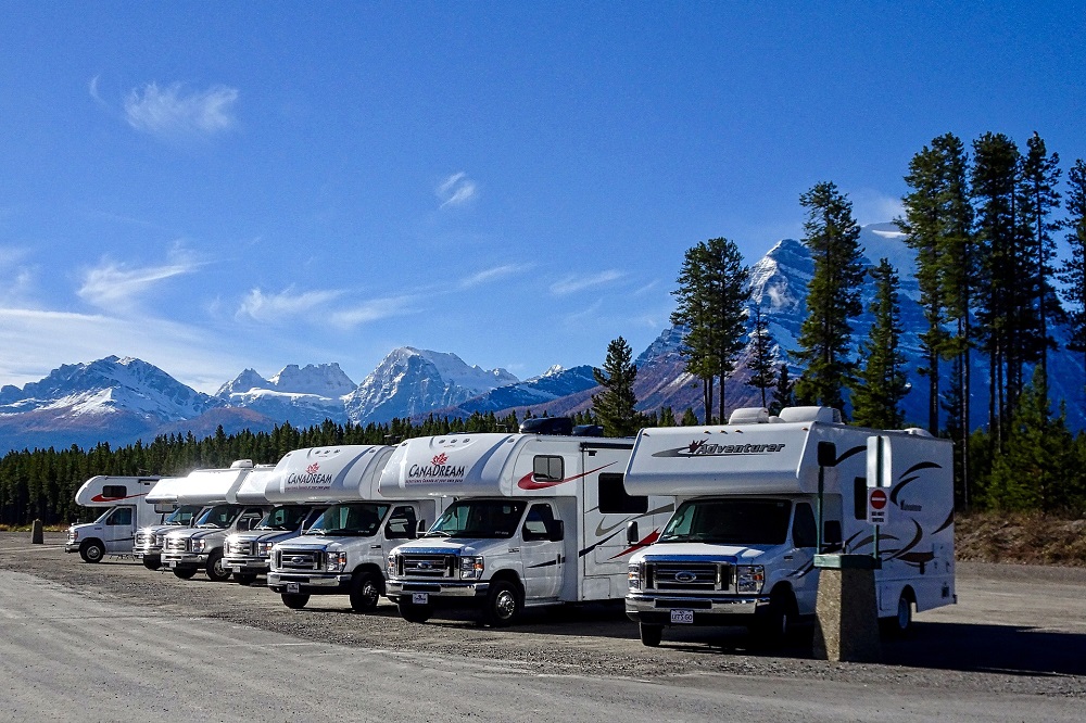 Row of RVs, mountain backdrop