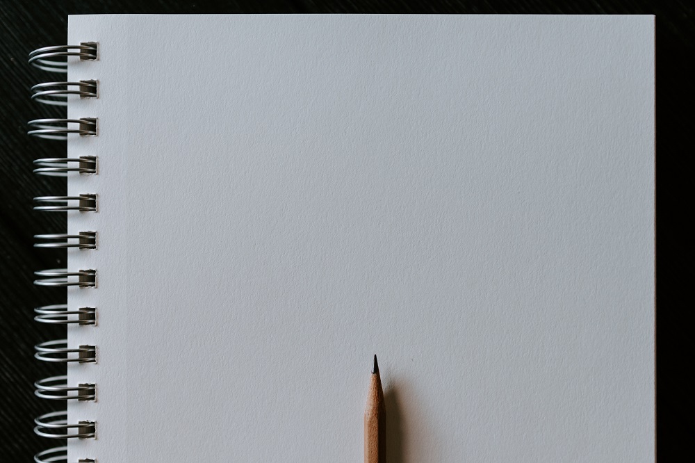 Wooden pencil on blank spiral notebook