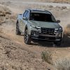 Front view of 2022 Hyundai Santa Cruz driving downhill on off-road trail