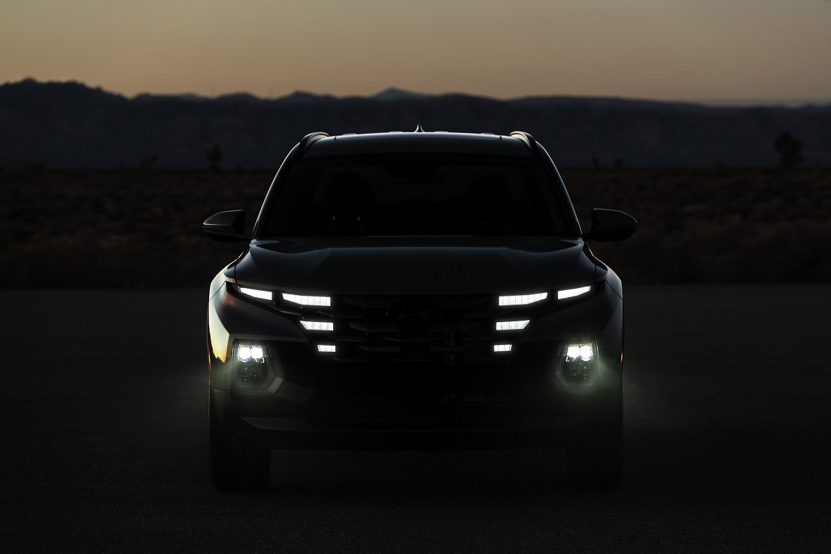 Front view of 2022 Hyundai Santa Cruz grille and headlamps in the dark