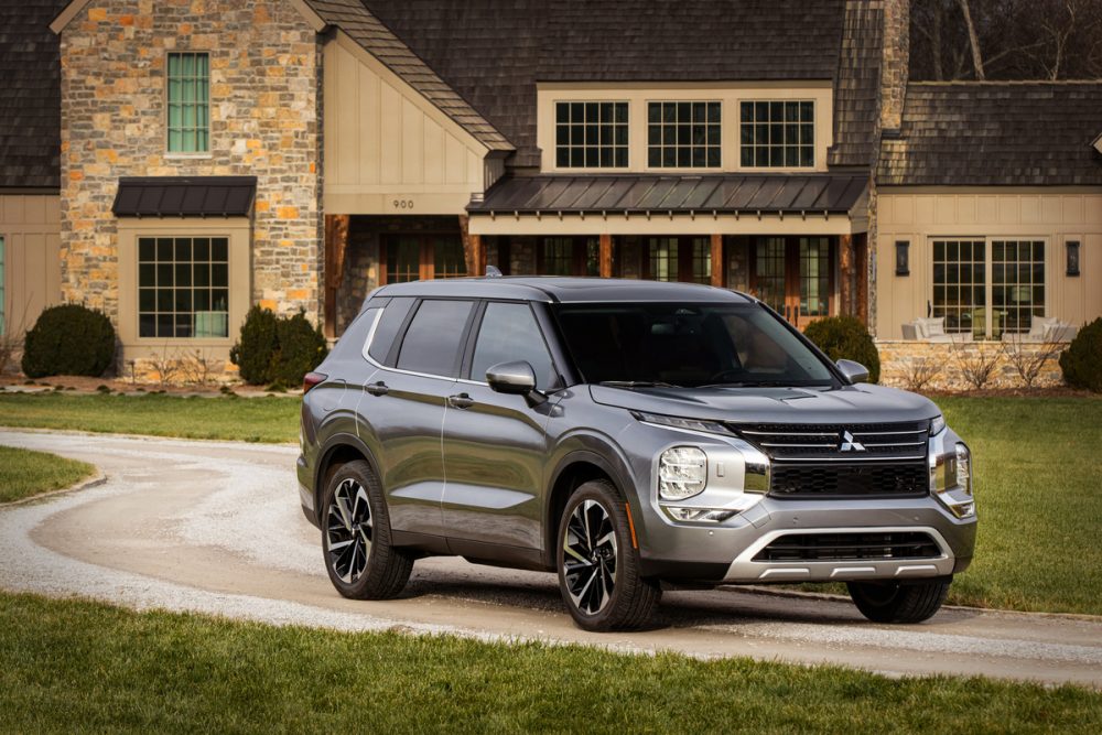 The 2022 Mitsubishi Outlander in front of a house