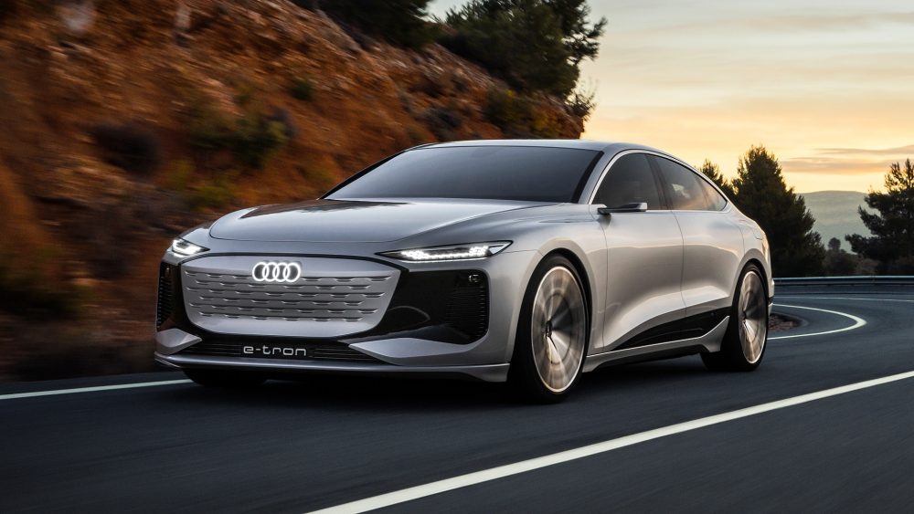 The new Audi A6 e-tron Concept driving down a highway at sunset
