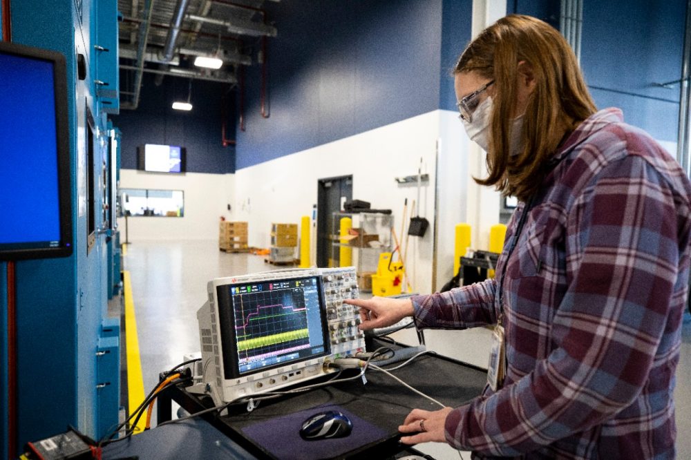 Battery validation engineer Mary Fedrick uses an Oscilloscope to test a battery at the the Battery Benchmarking and Test Laboratory in Allen Park, Michigan