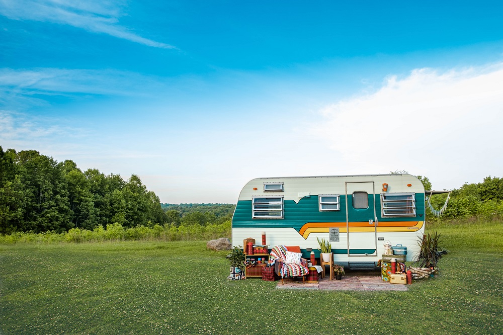 Red vintage camper in a field