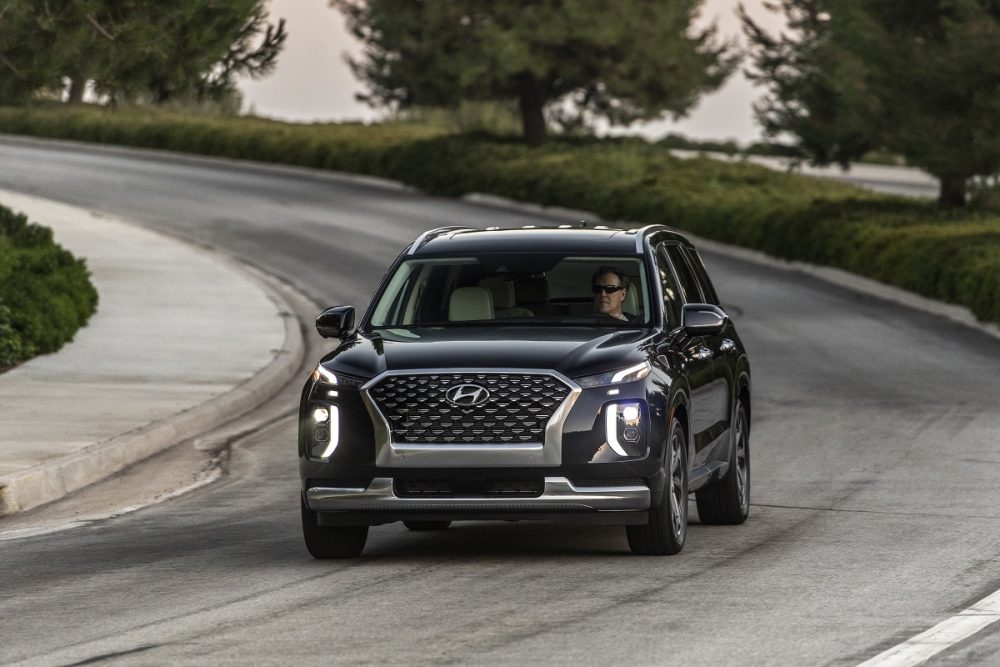 Front view of 2021 Hyundai Palisade driving around curve