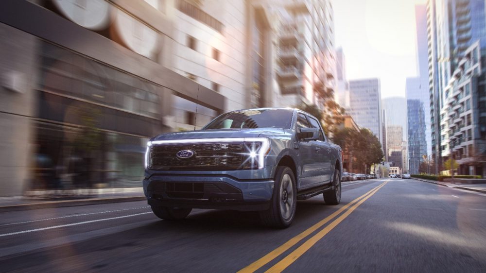 2022 Ford F-150 Lightning Platinum driving through a city