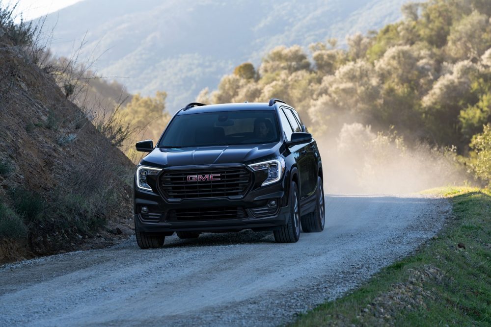 Front view of 2022 GMC Terrain Elevation Edition driving on gravel road