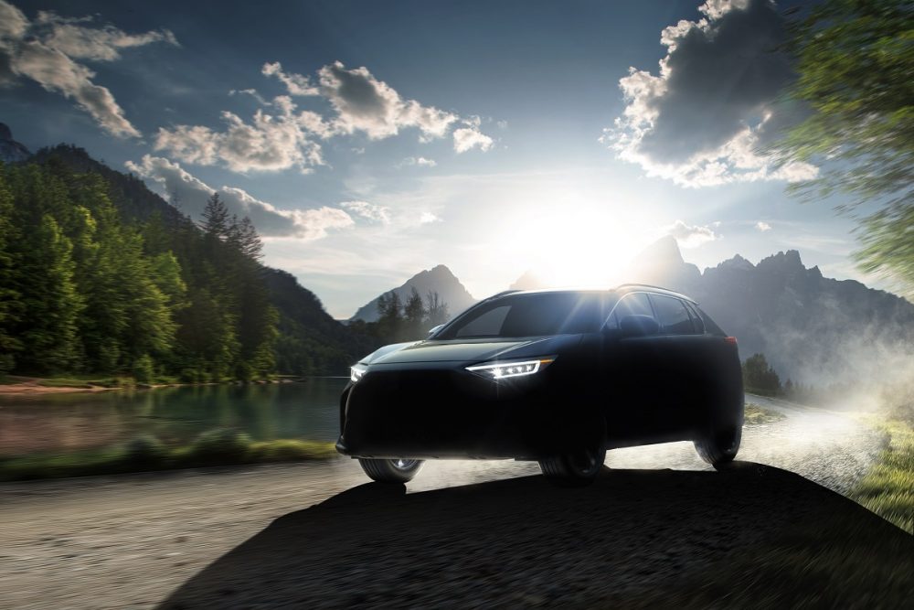 Shadowy image of Subaru Solterra SUV with mountains behind