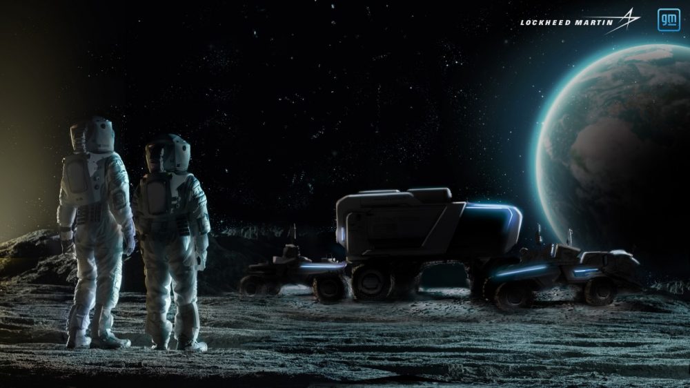 Two astronauts look at General Motor's new Lunar Terrain Vehicle on the moon, with the Earth in the background.