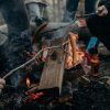 Grilling wieners over a campfire