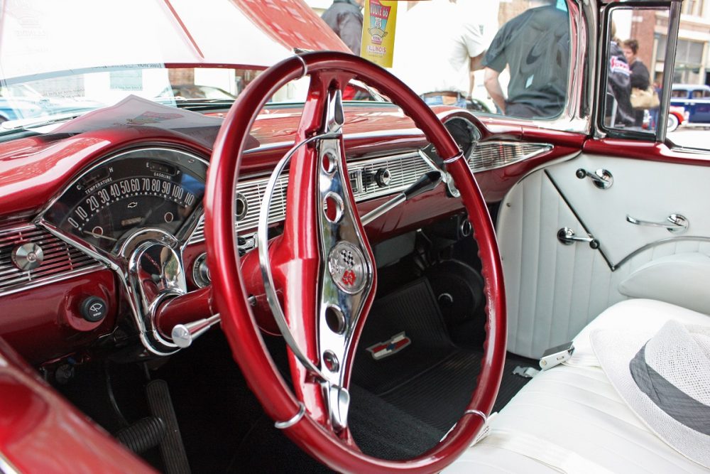 Photo of a candy apple red 1956 Chevrolet Bel Air Convertible interior and its large steering wheel