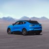 rear angle view of a 2021 Ford Mustang Mach-E GT in Grabber Blue in the desert