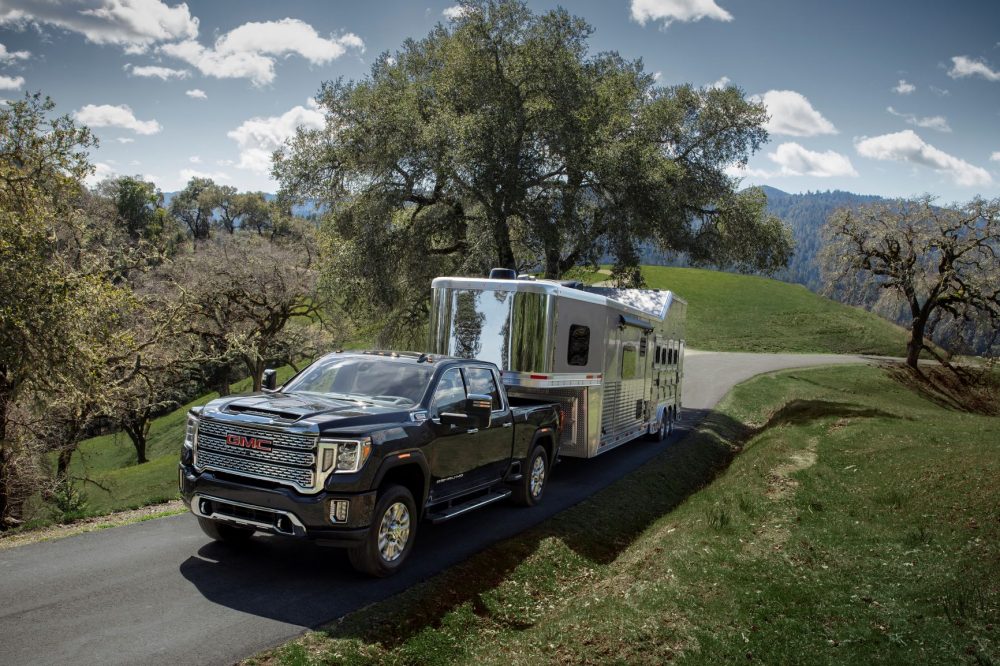 Front side view of 2021 GMC Sierra 2500HD towing a trailer