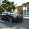 Front side view of 2021 Genesis G80 driving down street