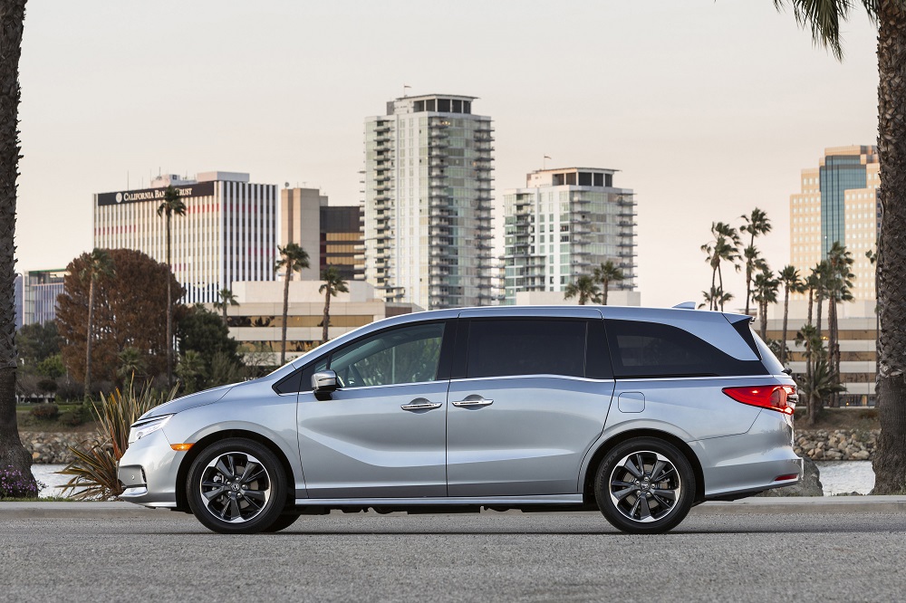 2021 Honda Odyssey with city buildings and palm trees in the background