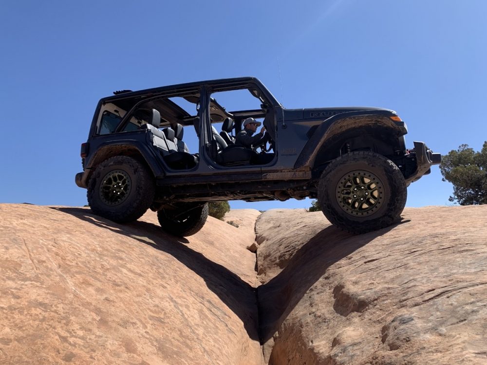 The 2021 Jeep Wrangler Rubicon 392 with the Xtreme Recon Package climbing on rocks