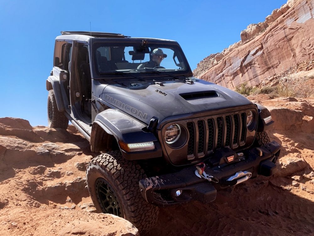 The 2021 Jeep Wrangler Rubicon 392 with the Xtreme Recon Package driving on rocks