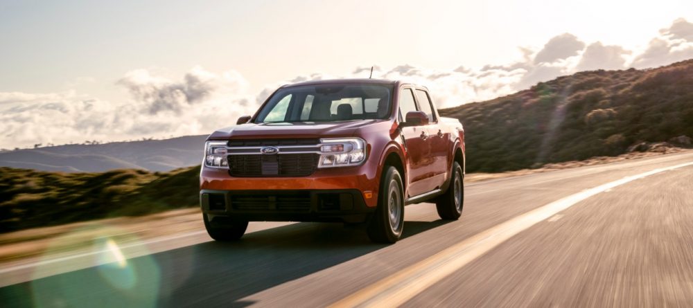 2022 Ford Maverick Lariat with 2.0-liter EcoBoost AWD in Hot Pepper Red driving along a mountain road