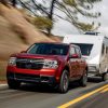 2022 Ford Maverick Lariat with 2.0-liter EcoBoost AWD in Hot Pepper Red towing a camper