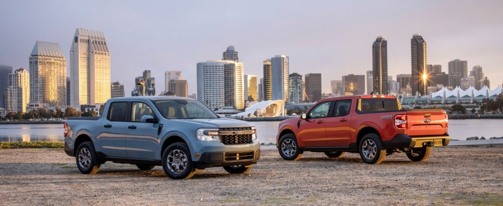 2022 Ford Maverick XLT hybrid and Maverick Lariat 2.0-liter EcoBoost with city skyline in background