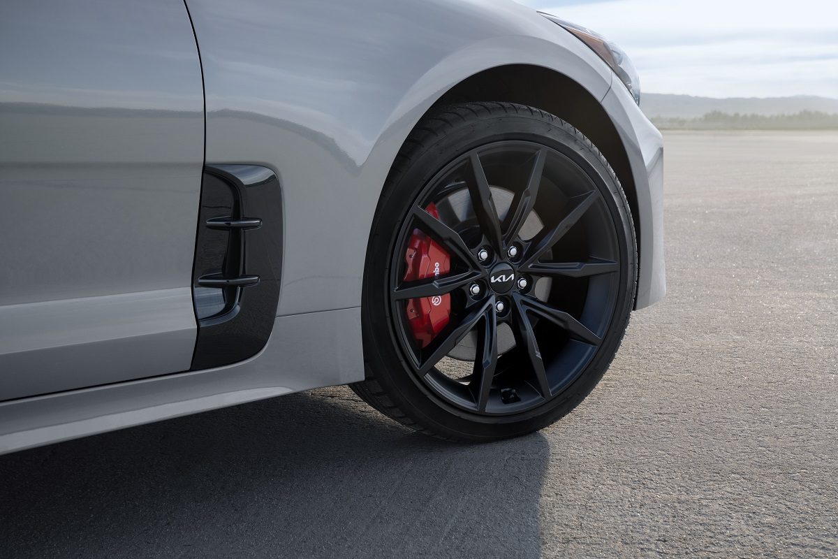 Close up view of 19-inch black wheels on the 2022 Kia Stinger Scorpion Special Edition in Ceramic Silver