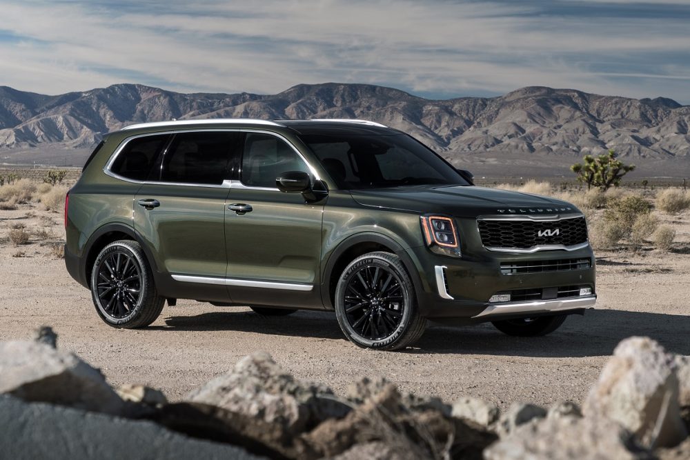 Dark green 2022 Kia Telluride parked in front of mountains