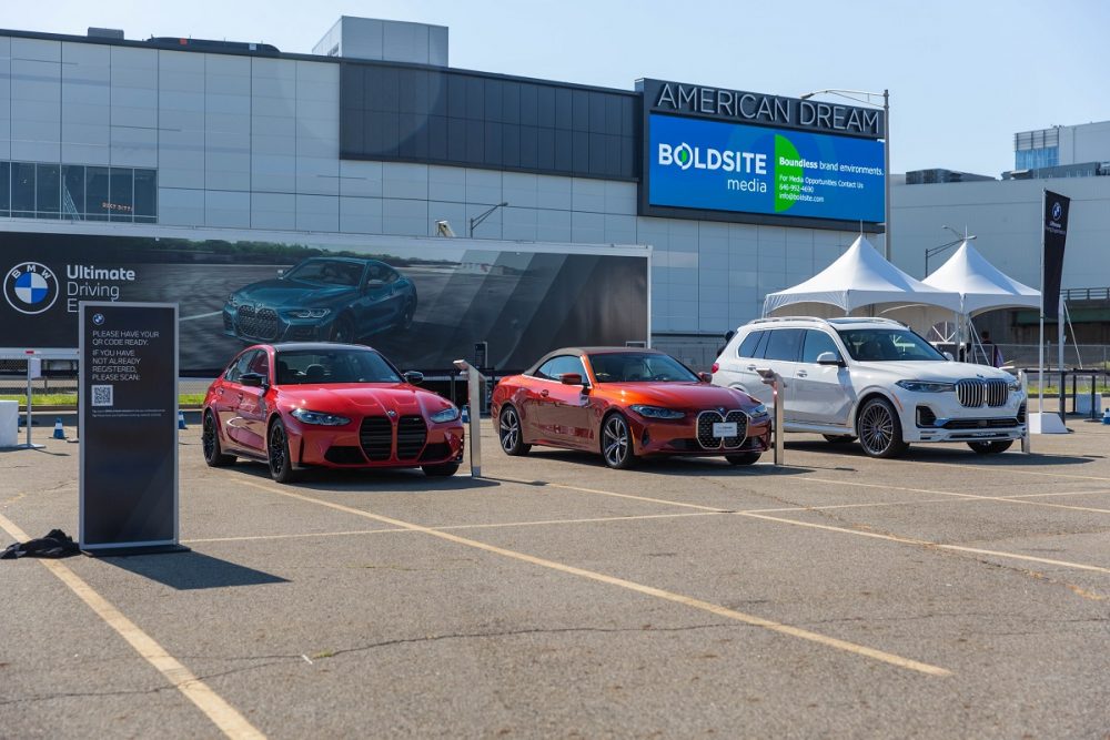 Three BMW vehicles parked at a BMW Ultimate Driving Experience event