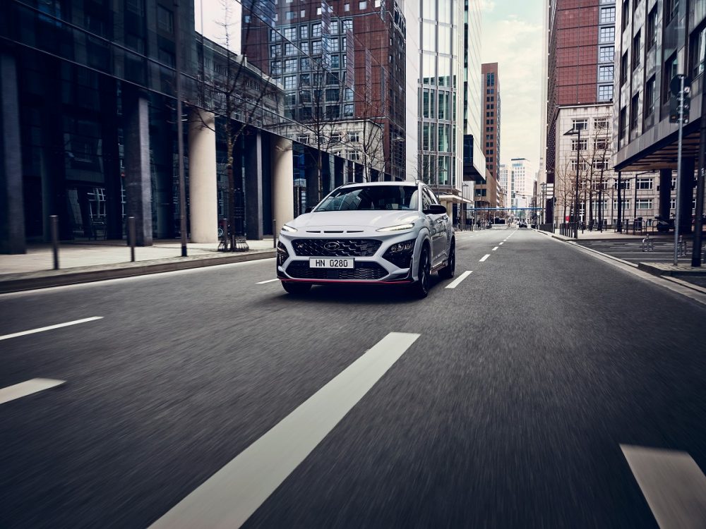 Front view of 2022 Hyundai Kona N driving on city street